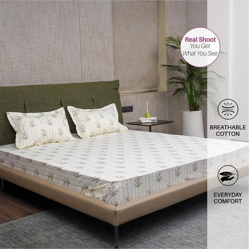 Floral fitted bedsheet with matching pillow covers on a bed