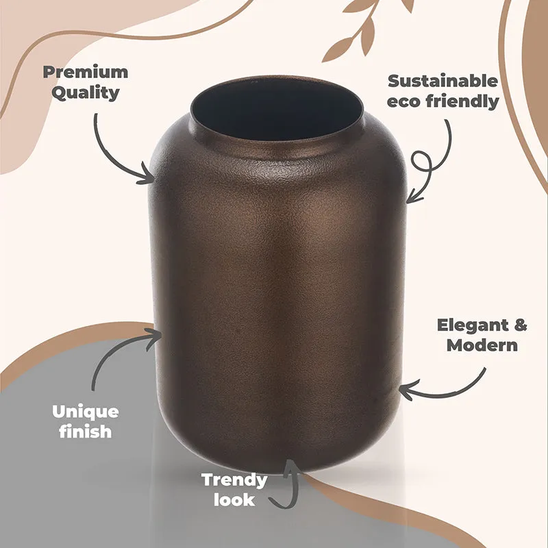 Brown textured metal vase shown against a graphic beige background