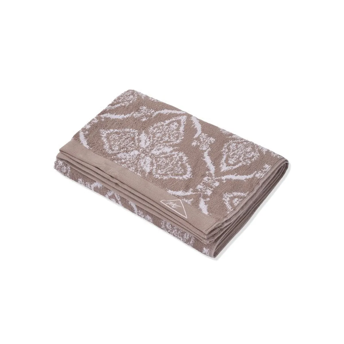 Folded beige floral bath towel shown against a white background