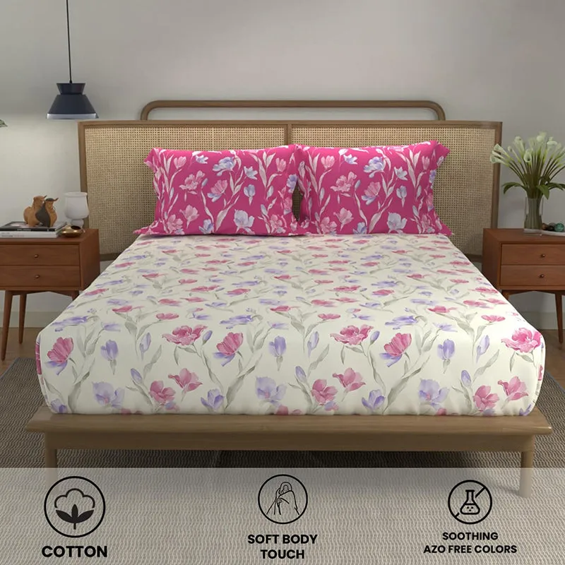 Front view of floral cream bedsheet with contrasting pink pillow covers