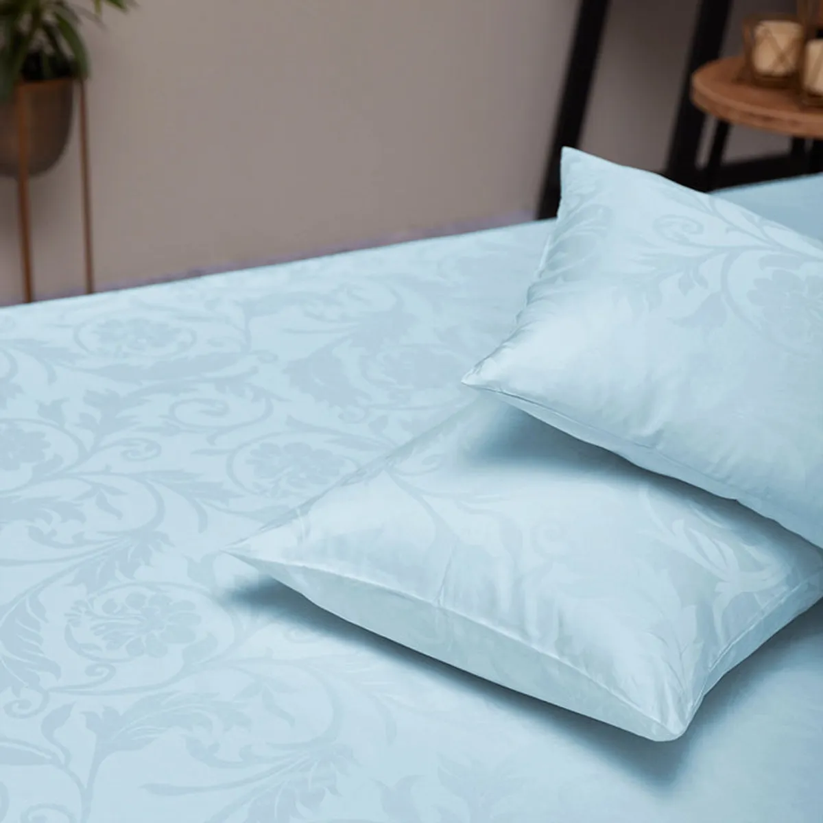 Pale blue floral jacquard duvet cover and pillow on a bed