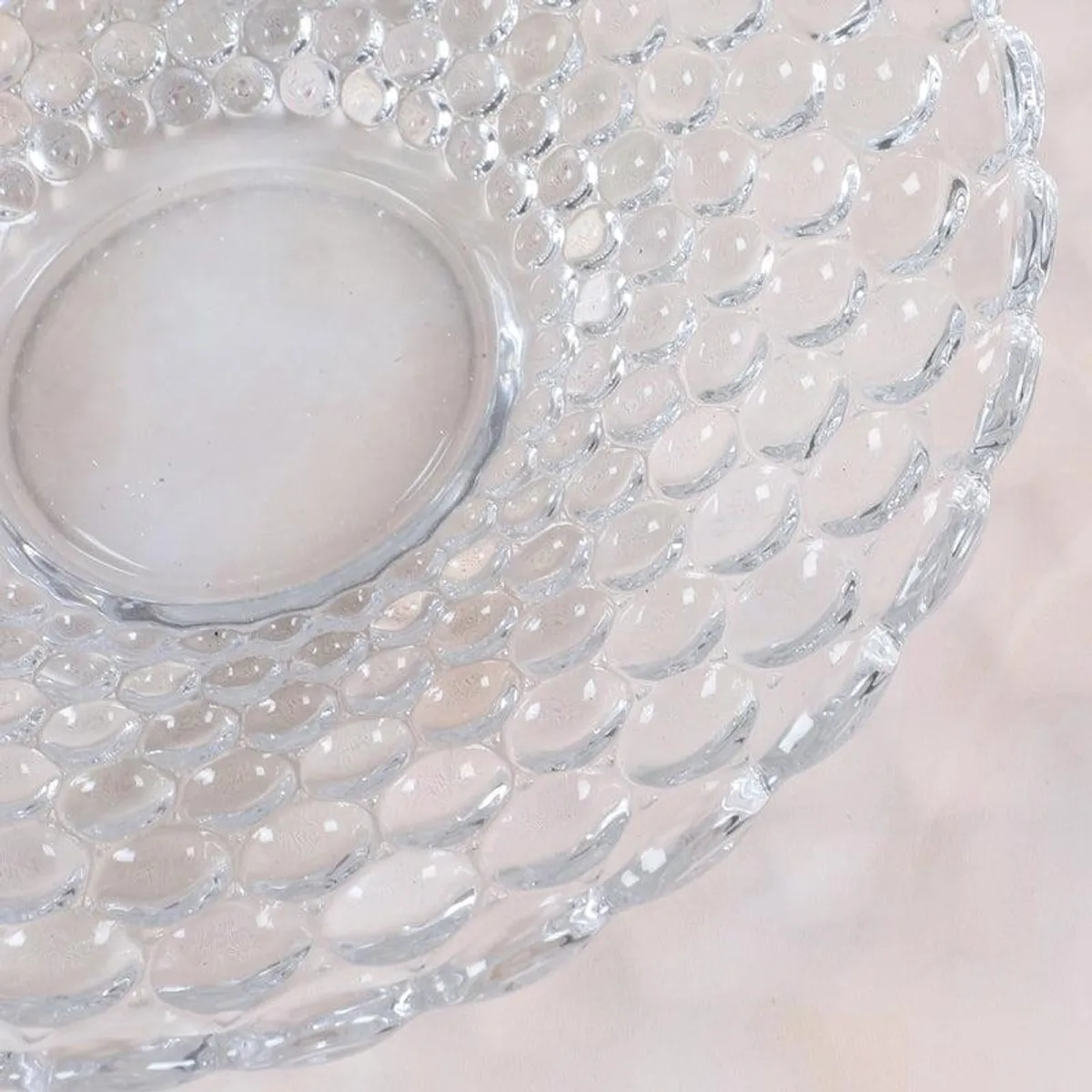 Close-up of the bubble-like textured surface on a transparent glass platter