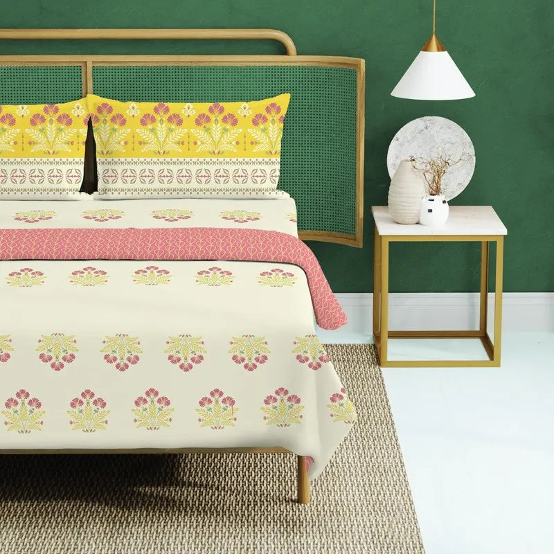 Close view of yellow floral pillow covers and off-white printed bedsheet