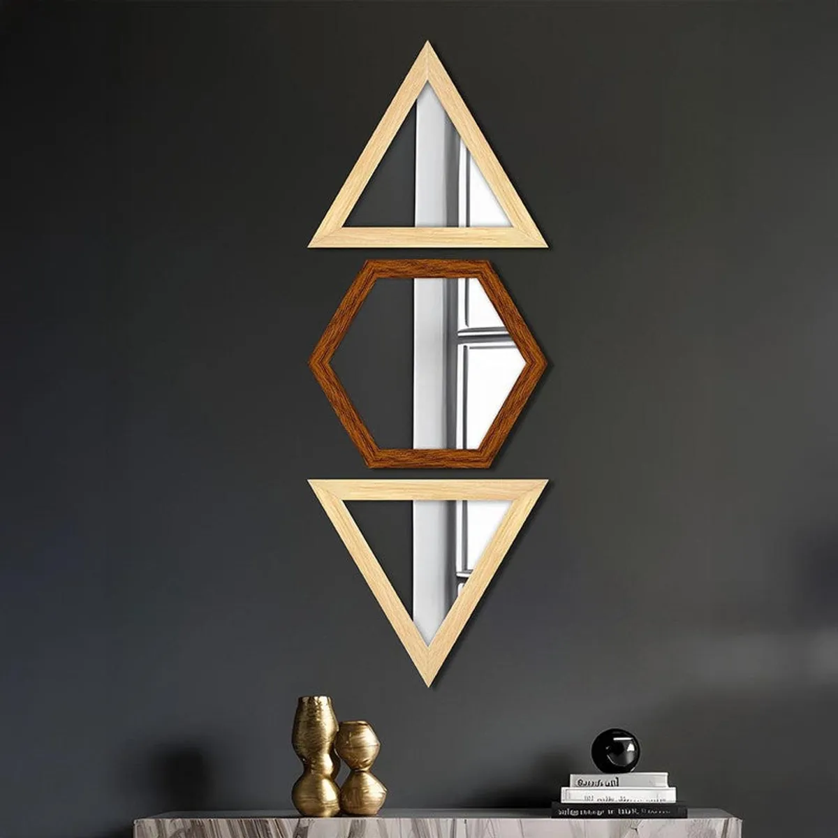 Vertical arrangement of beige triangle and brown hexagon wall mirrors on a dark wall