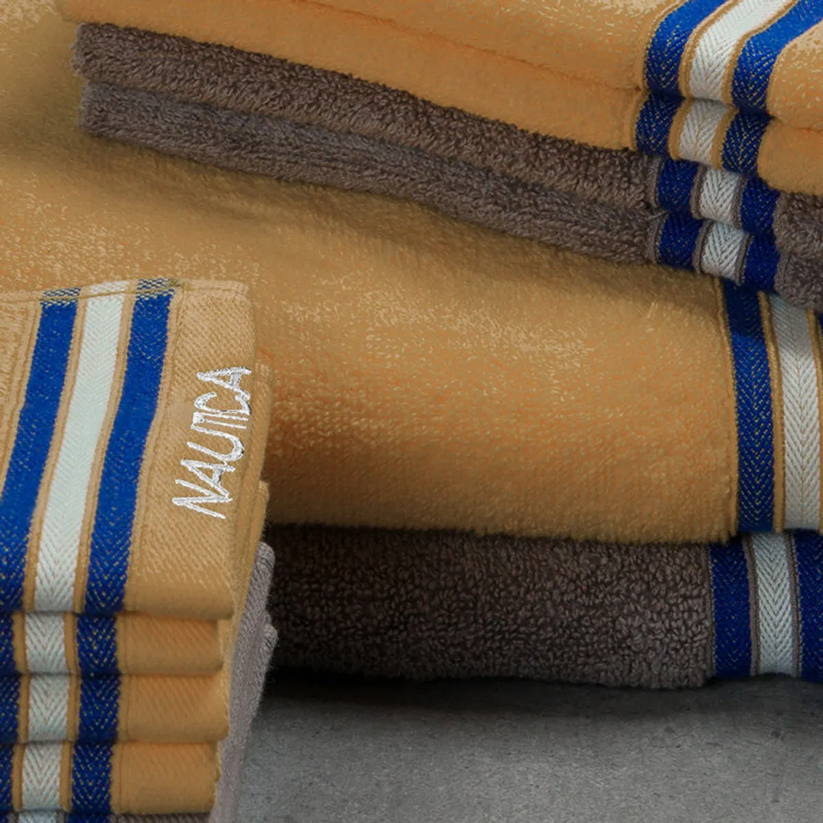 Close-up of folded yellow and grey towels with striped border detail