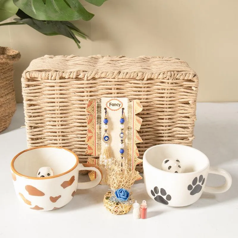 Woven basket with two dog-themed mugs and blue rakhi set