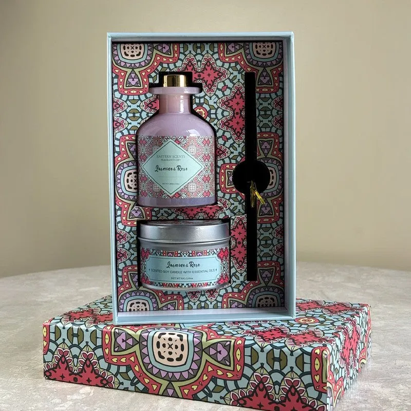 Pink diffuser and candle arranged inside an open colourful patterned presentation box