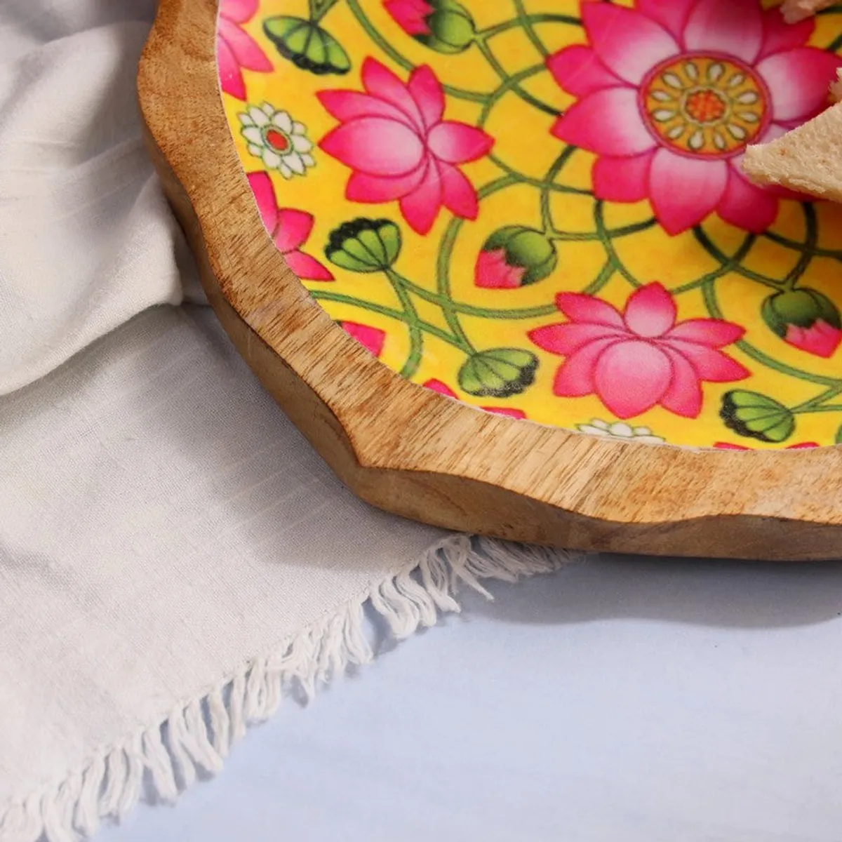 Close-up of the natural mango wood edge and pink floral platter design