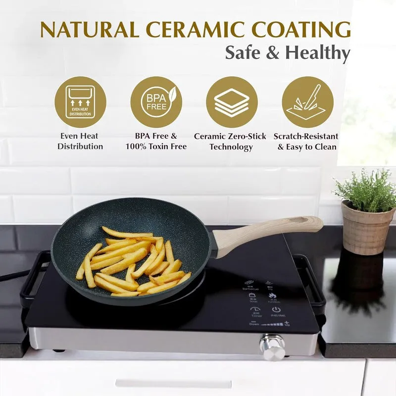 Black frying pan with ceramic coating shown cooking chips on an induction hob