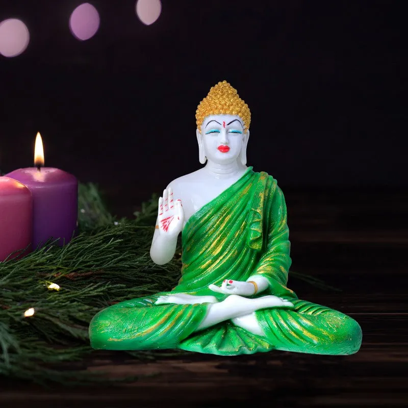 Green and white Buddha idol displayed on a dark surface