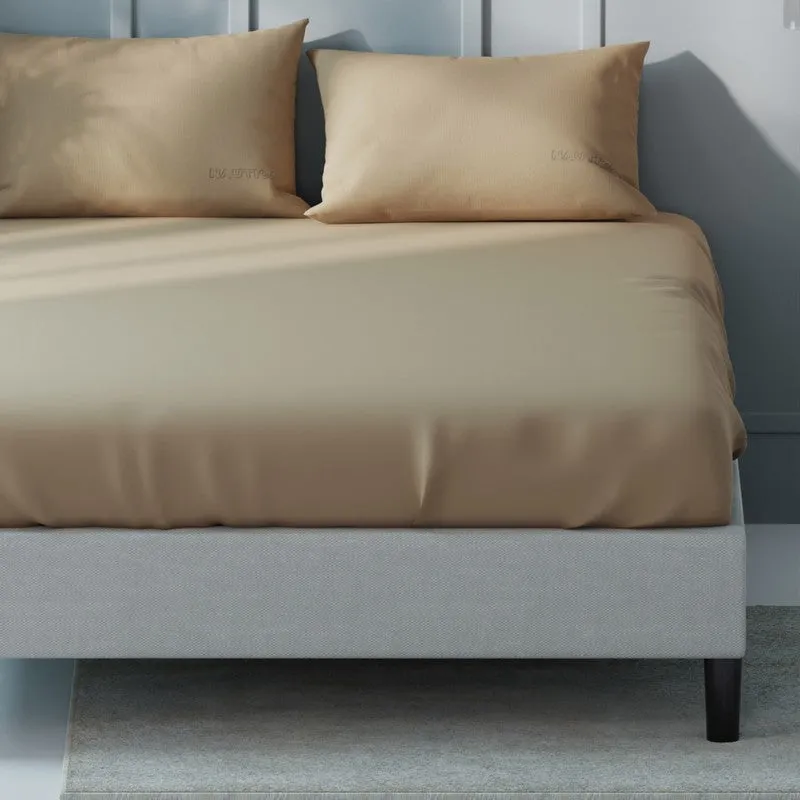Close-up of khaki solid bedsheet draped over a bed