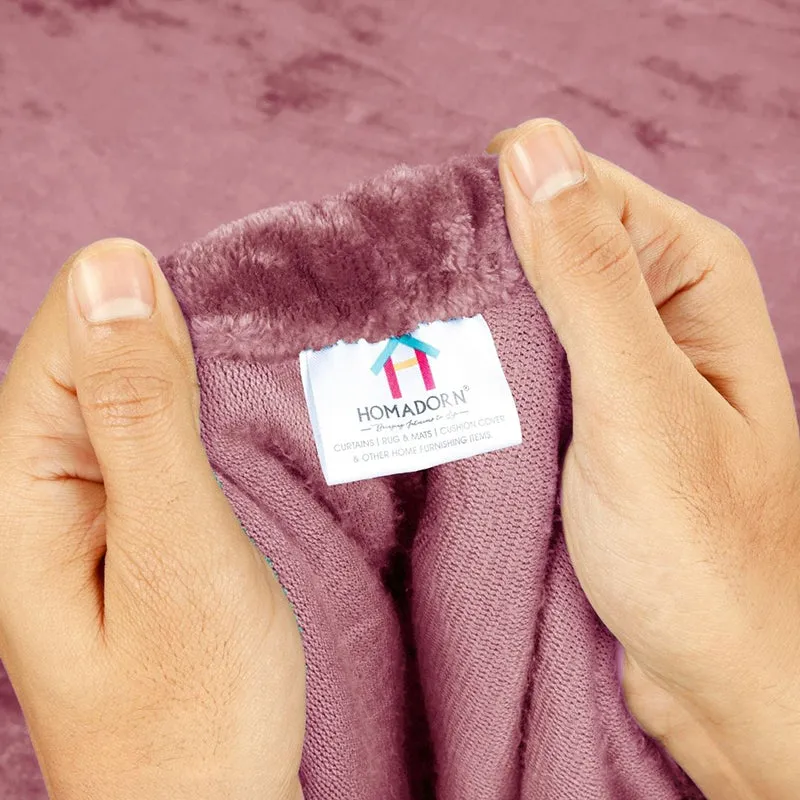 Hands stretching the elastic edge of the pink velvet fitted bedsheet