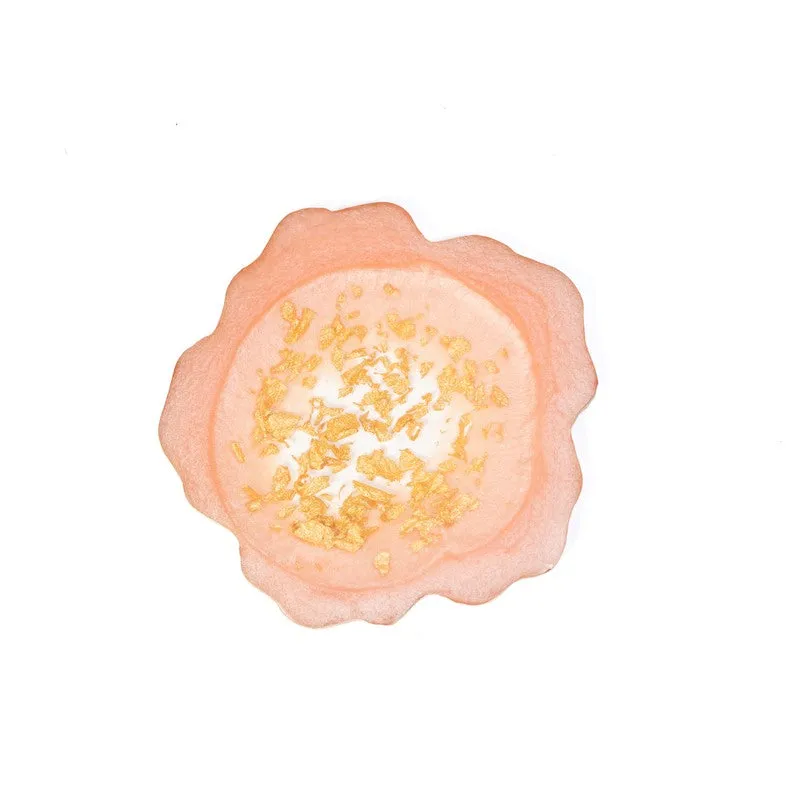 Single peach-pink coaster with gold detailing on a white background