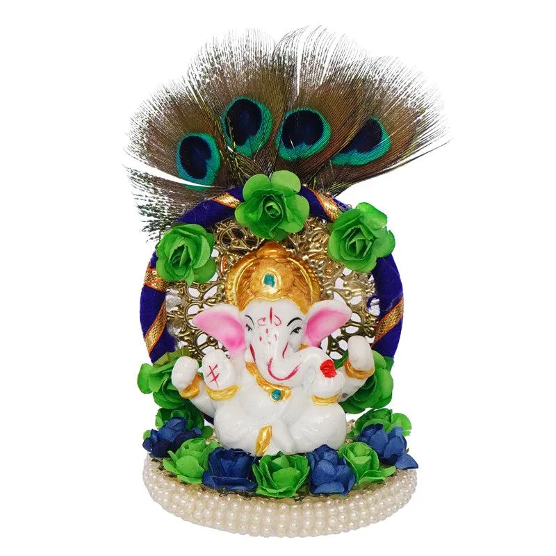 Front view of a multicoloured Ganesha idol with peacock feathers and floral decoration