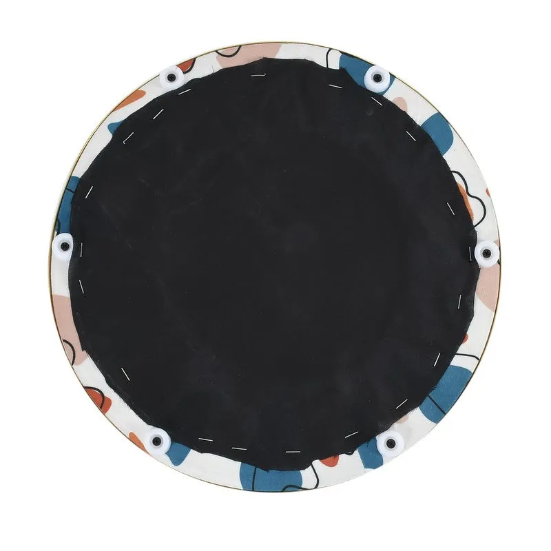 Underside view of the round pouffe showing its dark base and feet
