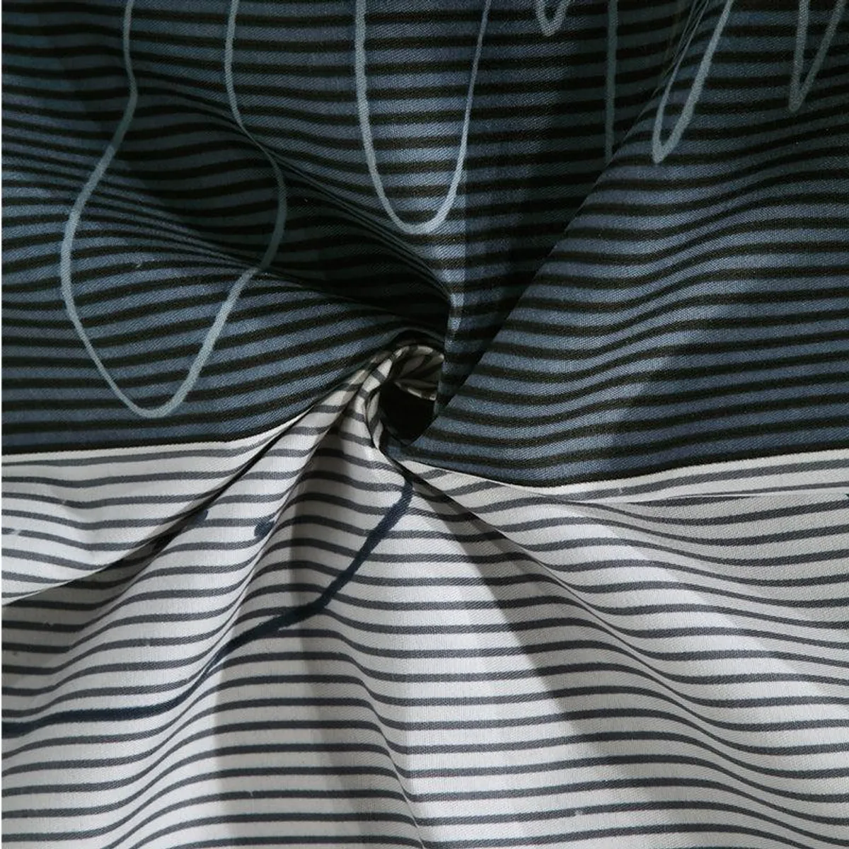 Close-up of soft blue and grey striped bedsheet fabric with abstract line print
