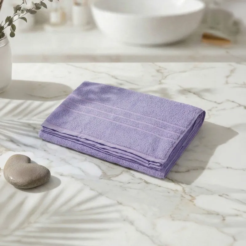 Folded lavender bath towel on a marble countertop