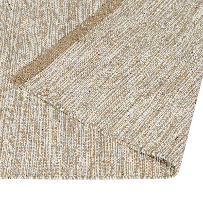 Close-up of the beige runner rug showing its textured weave and border