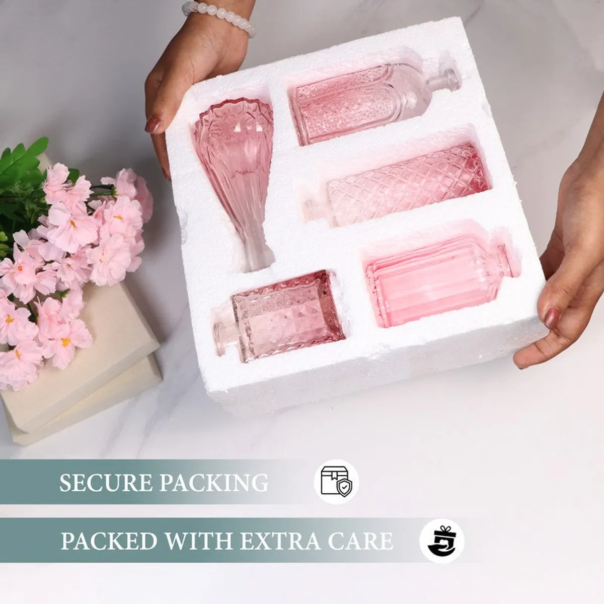 Five pink glass vases placed securely in protective packaging