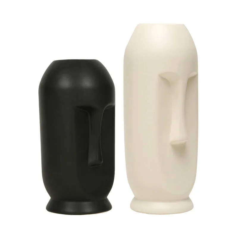 Side view of black and white face vases