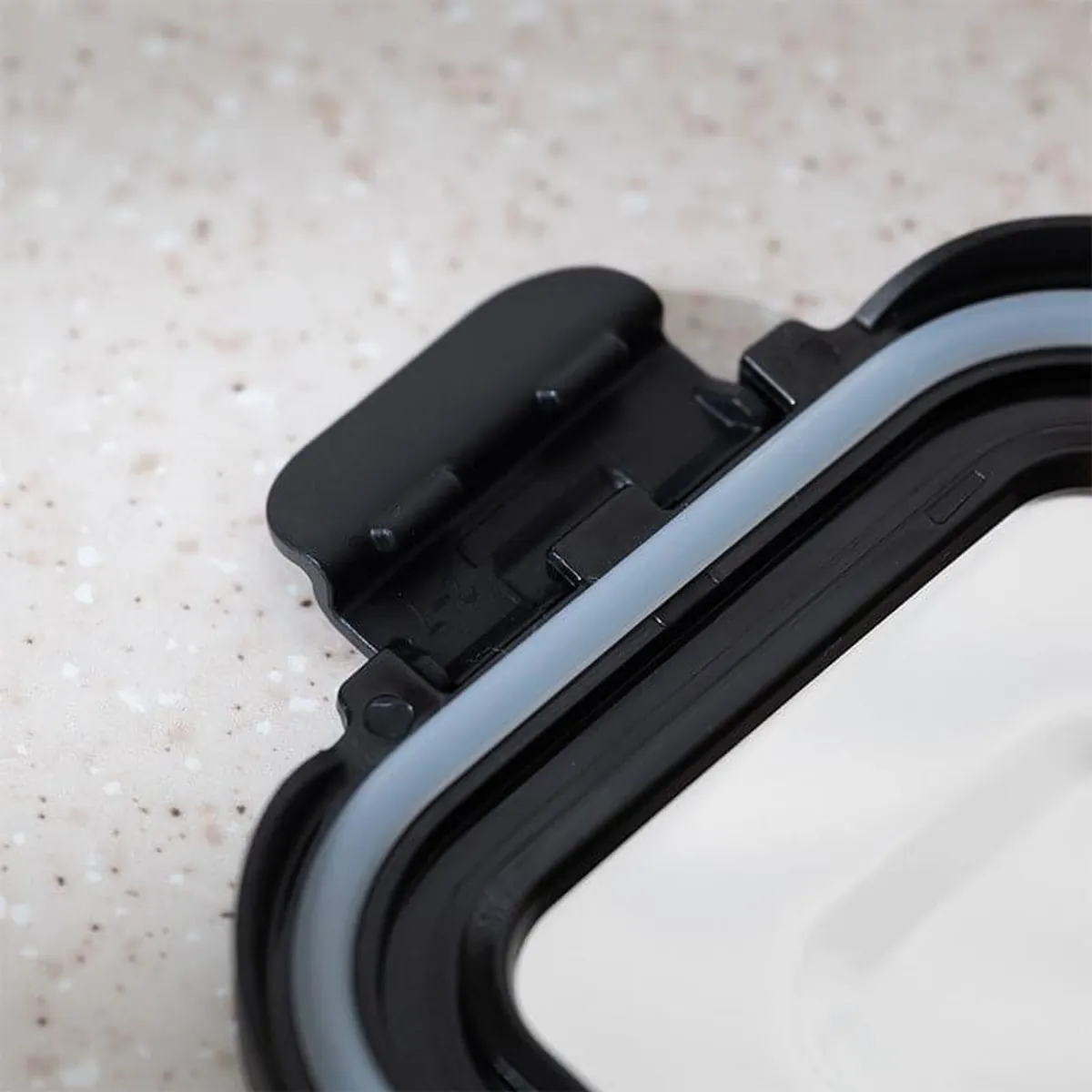 Close-up view of the black lid frame and sealing detail