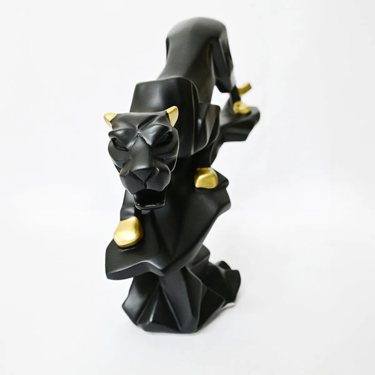 Front view of the black panther showpiece with gold paws and ears