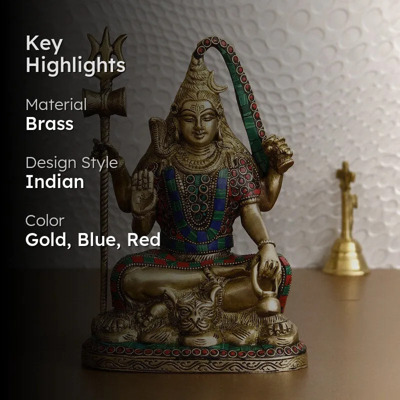 Gold-toned deity idol with blue and red accents and highlight text overlay