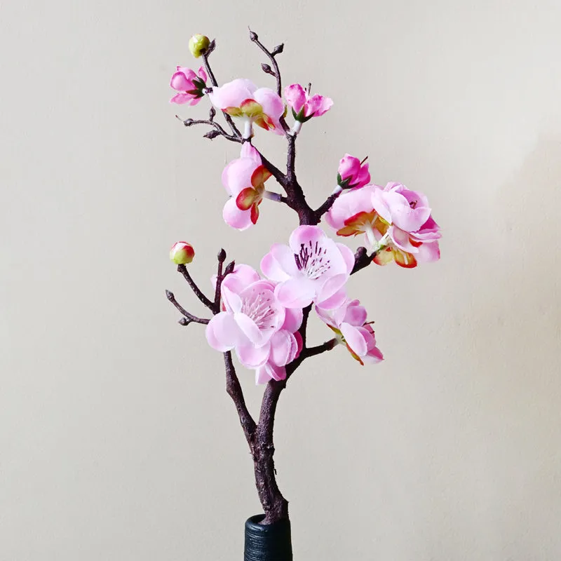 Single pink artificial plum blossom stick with open flowers and buds