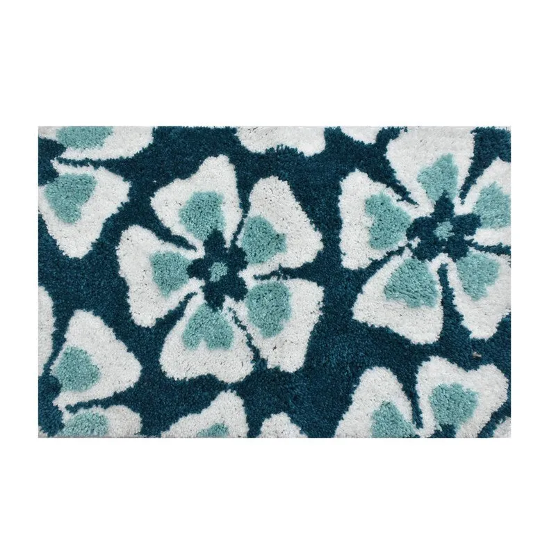 Close-up of the green and white floral textured bath mat surface