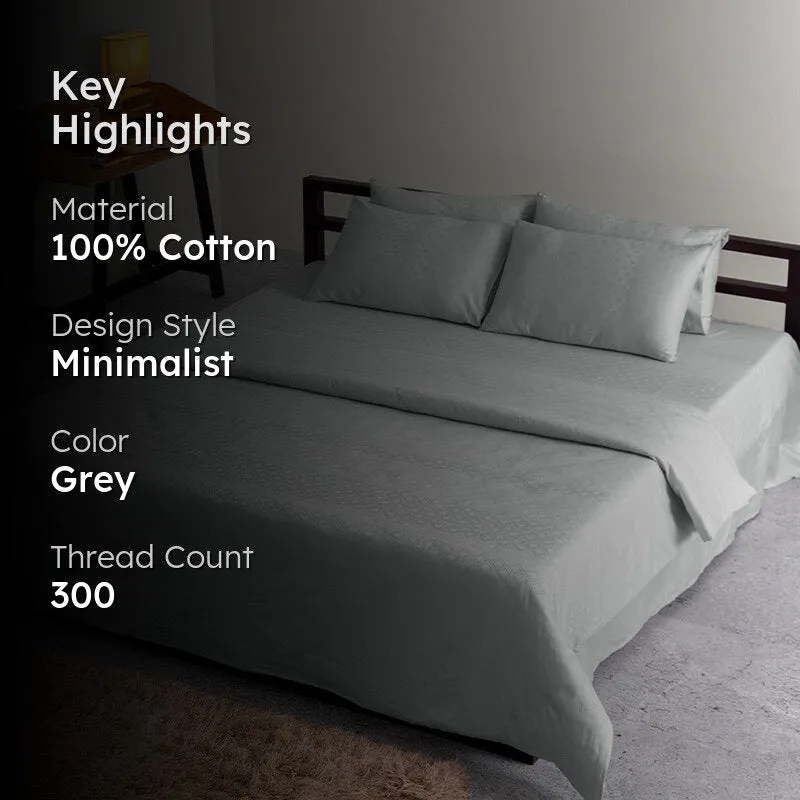 Light grey geometric duvet cover styled on a bed in a bedroom