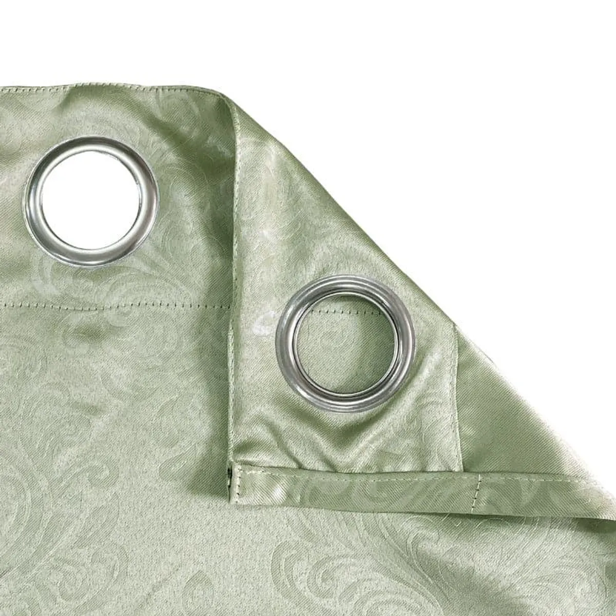 Close-up of silver eyelets on the green jacquard curtain fabric
