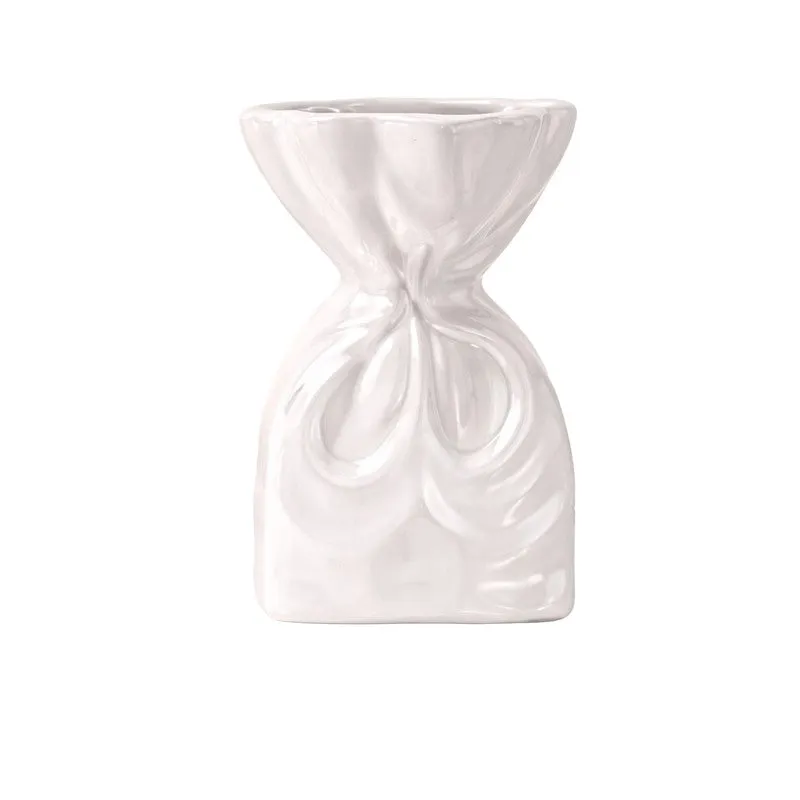 Front view of a glossy white sculptural ceramic vase on a plain white background