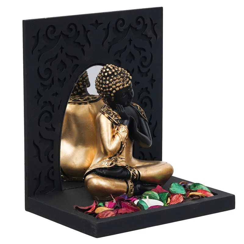 Side angle of black and gold Buddha tea light holder with mirrored arch opening