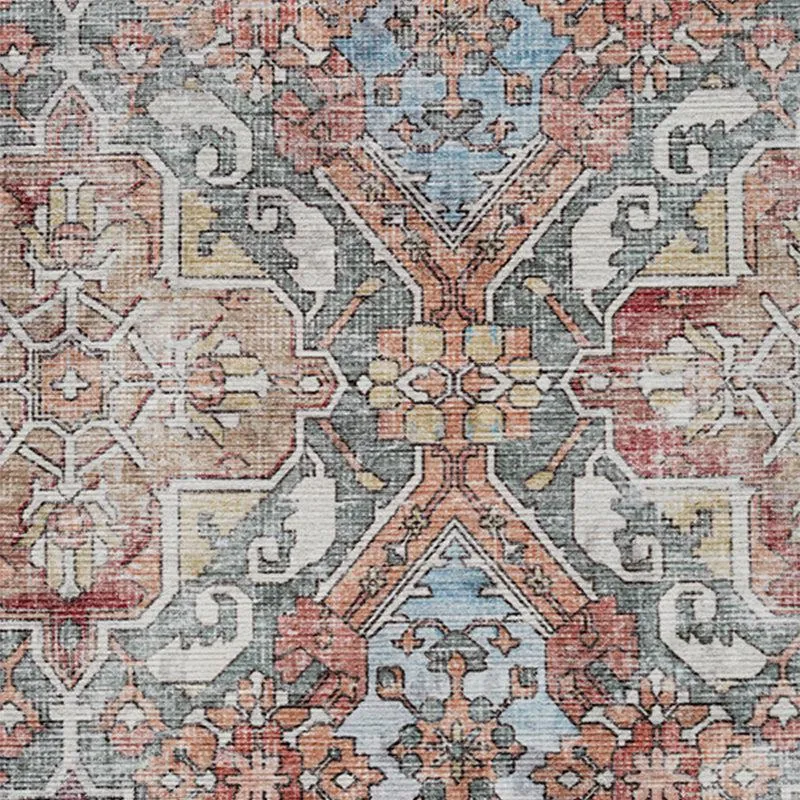 Close-up of ornate ethnic motif in muted blue, grey, beige and rust tones