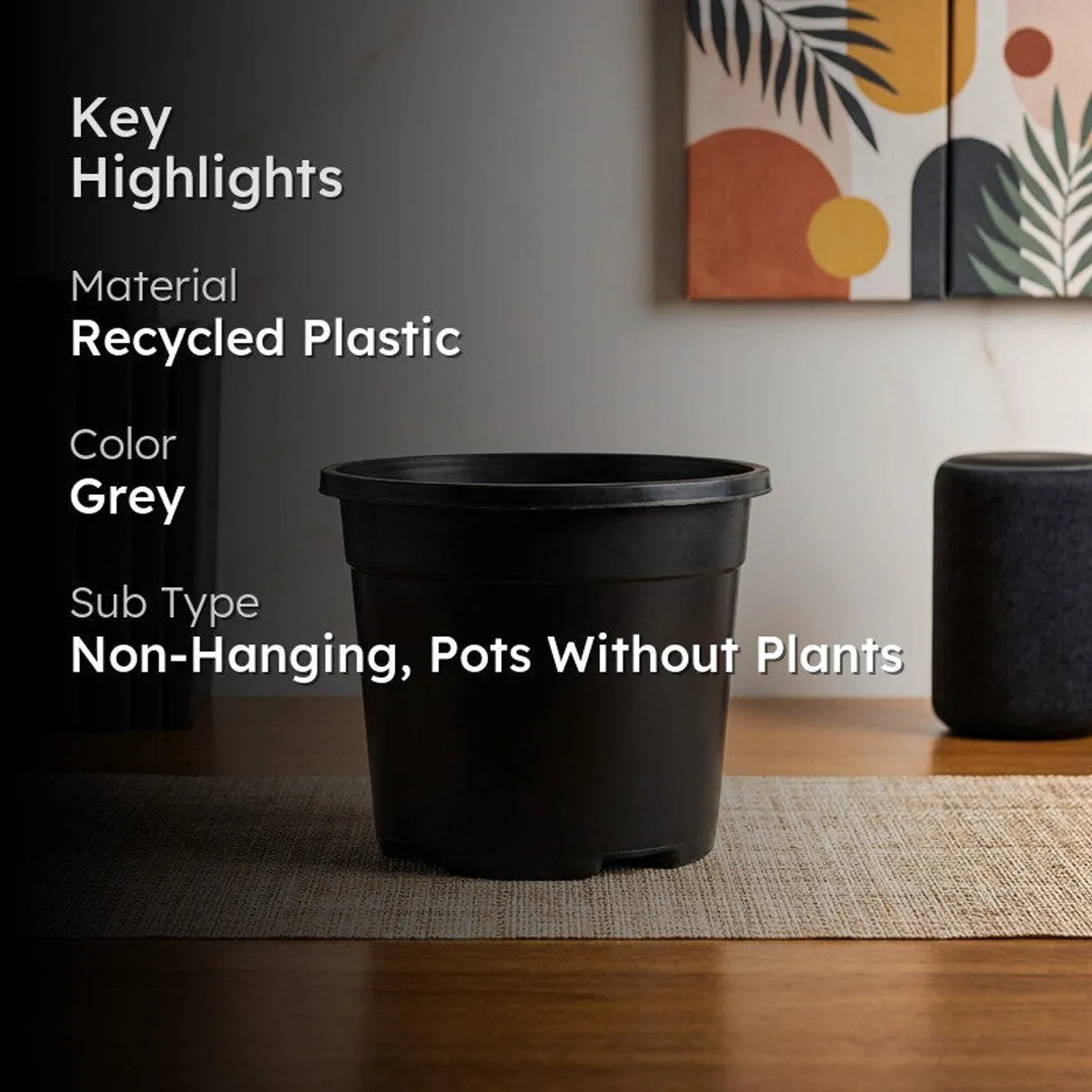 Grey plastic plant pot styled in a modern indoor setting
