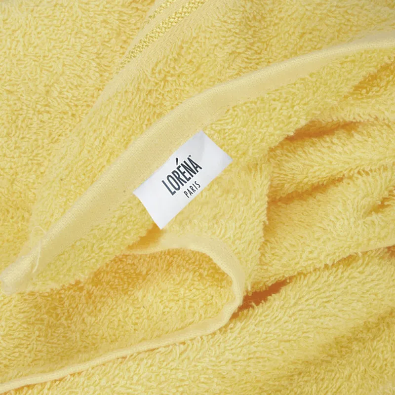 Close-up of soft yellow towel texture and folded edge