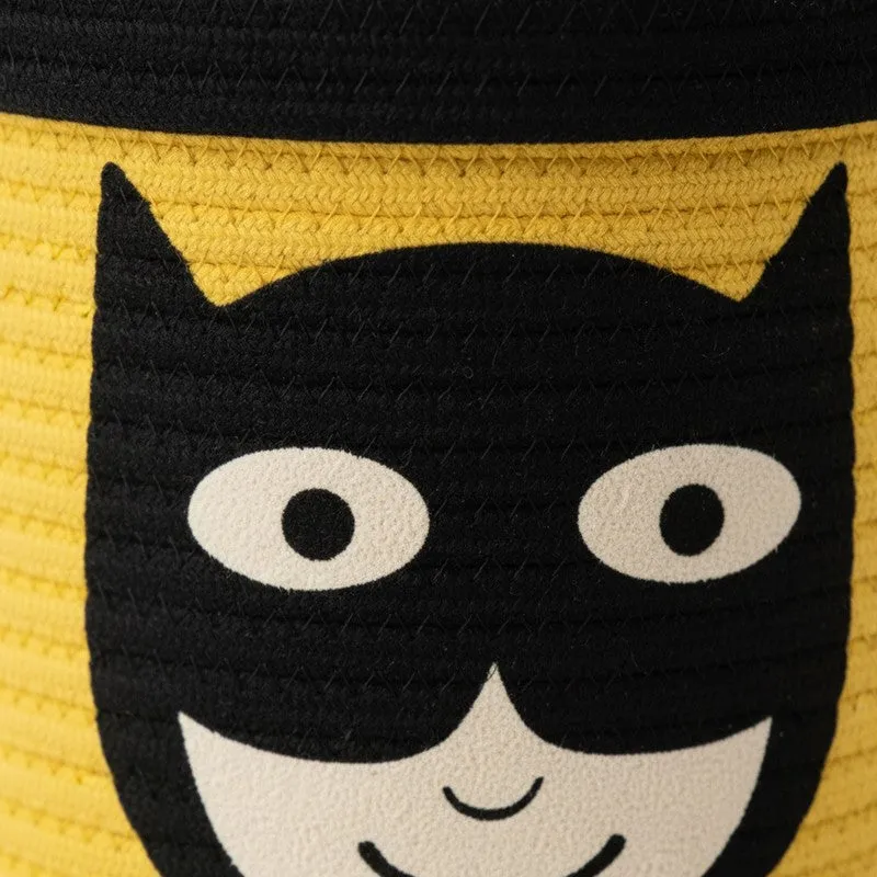 Close-up of the black superhero face motif on the yellow basket