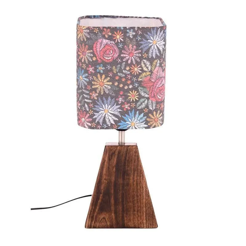 Multicolour floral fabric table lamp with a tapered brown base on white background