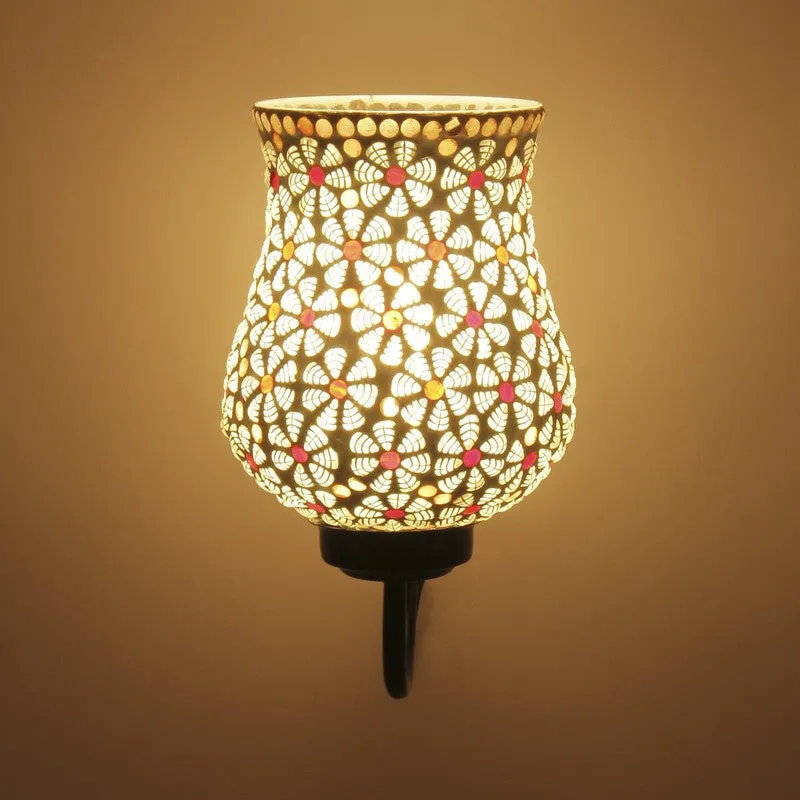 Close view of illuminated white mosaic glass wall lamp with floral pattern