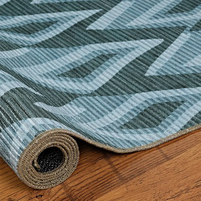 Rolled edge of blue textured carpet showing thickness