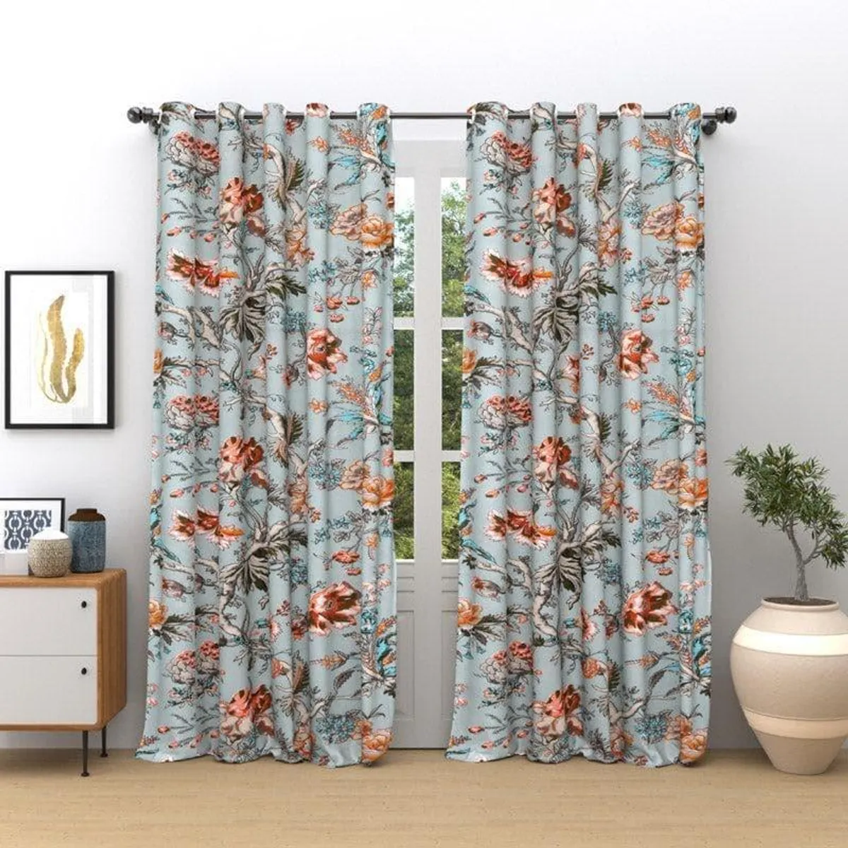 Floral blue curtains framing a bright window in a living room