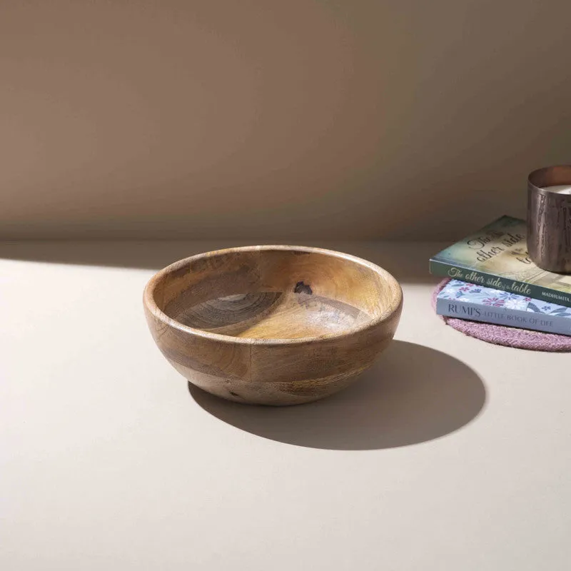 Top view of a round brown wooden serving bowl