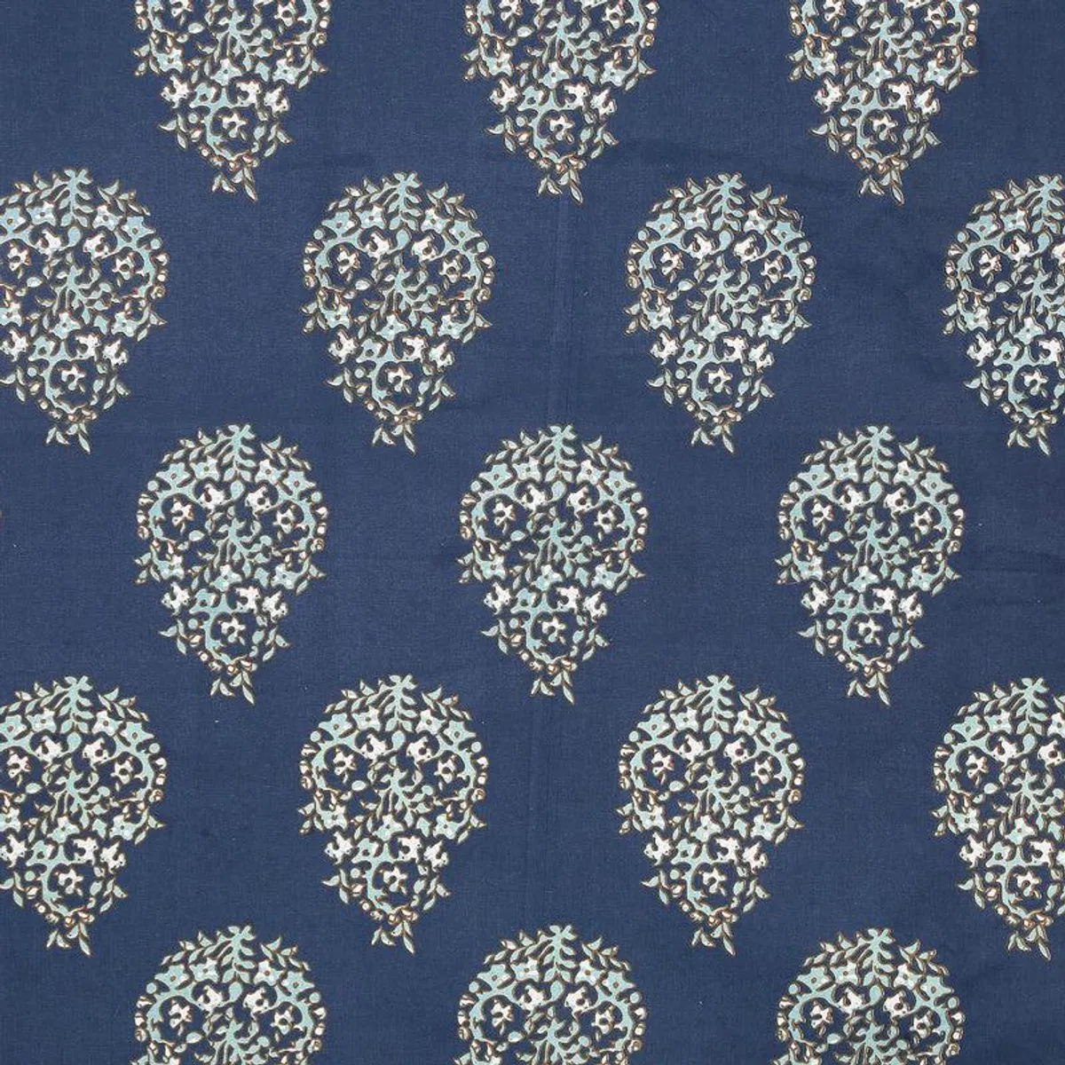 Blue fabric with repeating white and aqua ethnic floral motifs