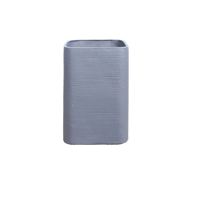 Front view of an empty grey rectangular planter on a white background