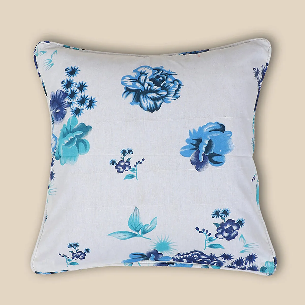 White cushion cover featuring scattered blue and teal floral motifs