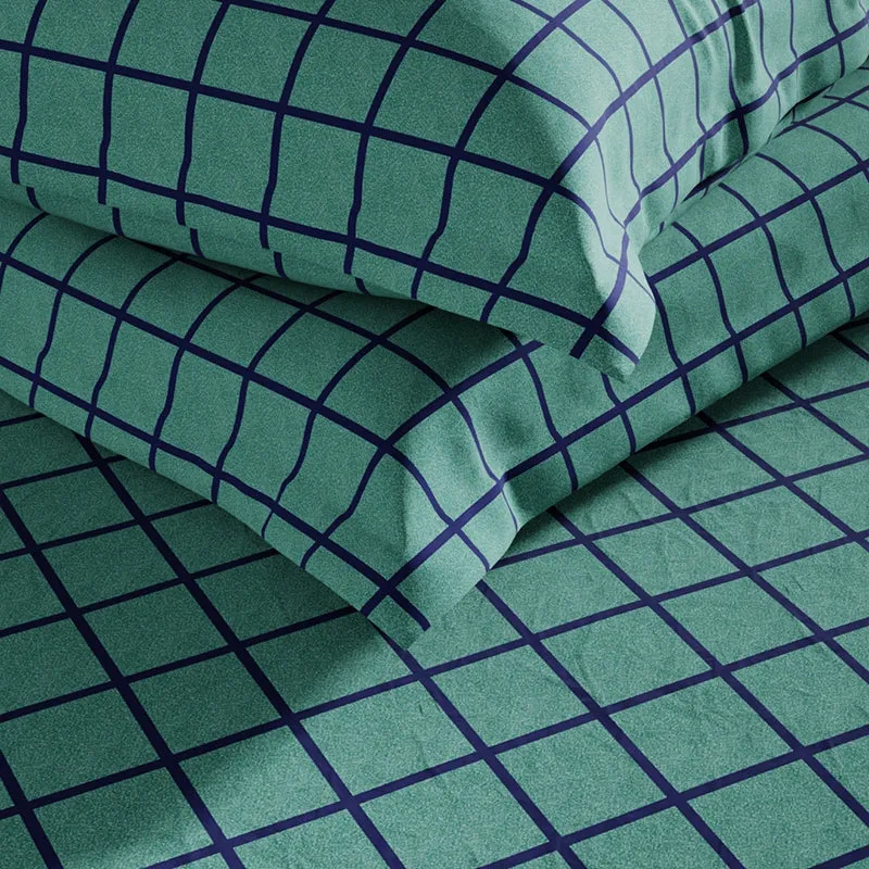 Folded green checked cotton bedsheet showing its soft surface