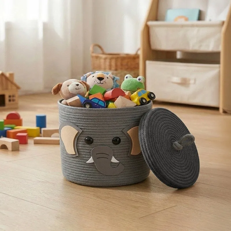 Grey cylindrical storage basket with elephant face and lid, filled with toys