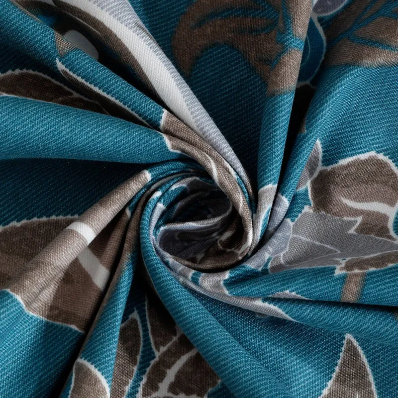 Close-up of the blue and grey bedsheet fabric twisted to show texture and print
