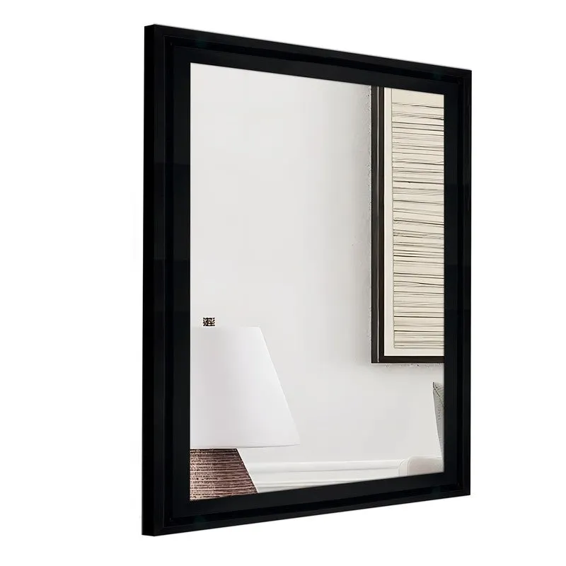 Angled view of a black rectangular framed wall mirror