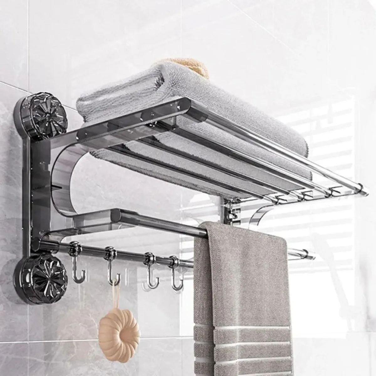 Silver wall-mounted hanger with shelf, hanging rail and hooks in a tiled bathroom